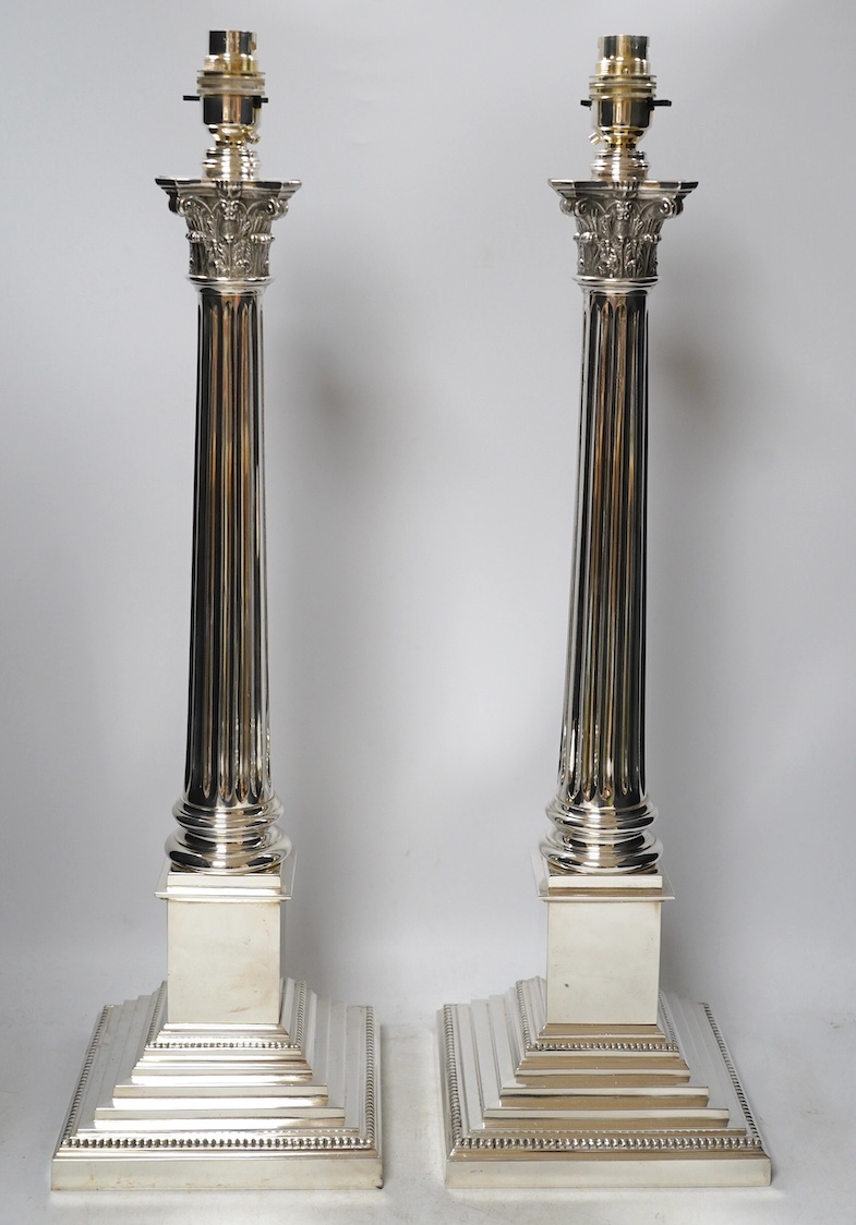 A pair of plated Corinthian column lamp bases, 56cm high including fitting. Condition - good